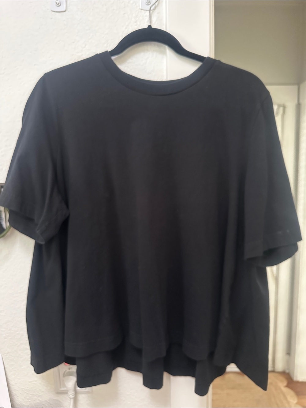 COS black crew neck tee with flared hem. Size M.
